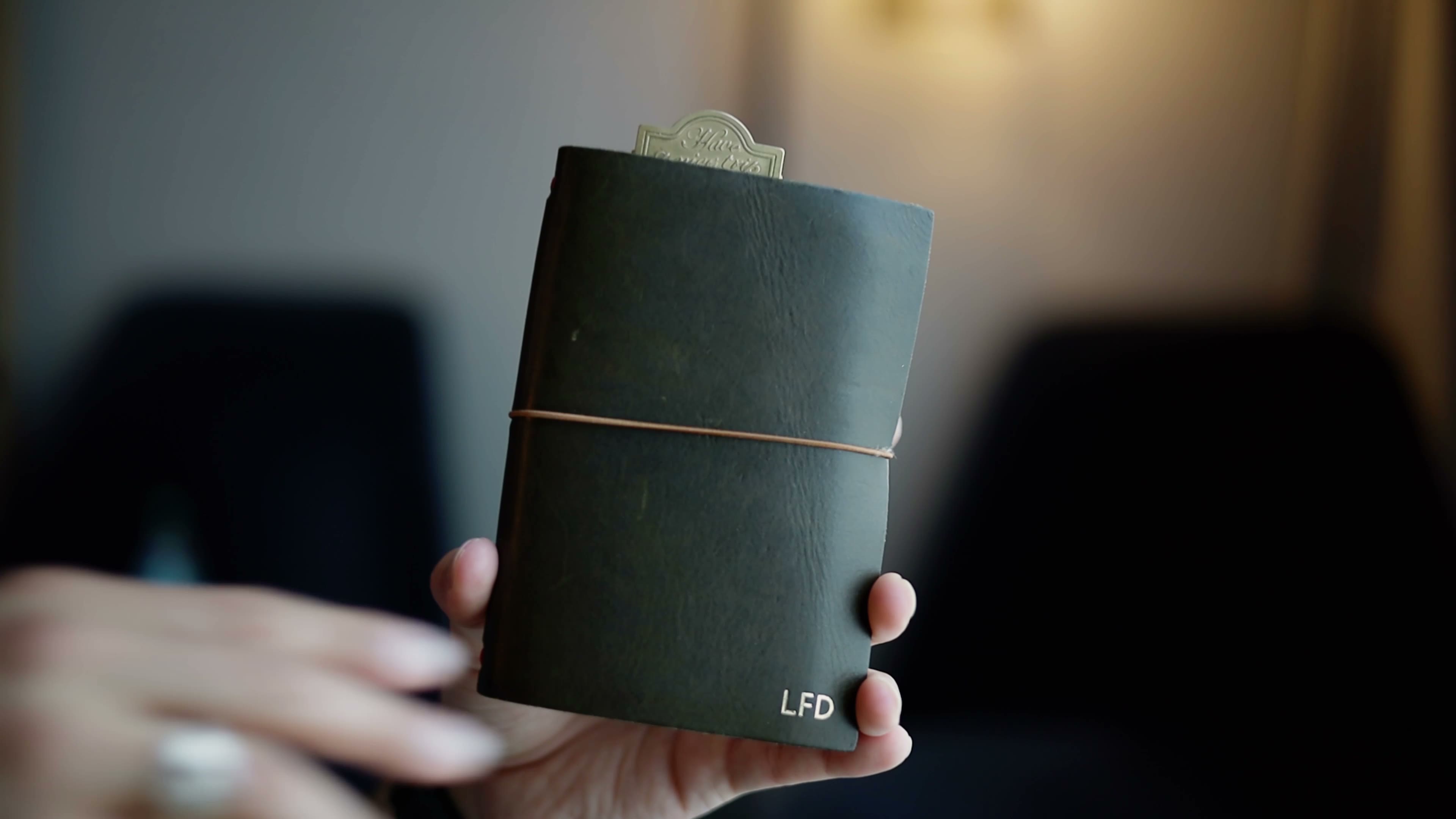 A Paper Republic leather journal held in one hand